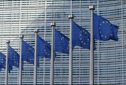 A view of the European Commission and its EU flags by Guillaume Perigois from Unsplash